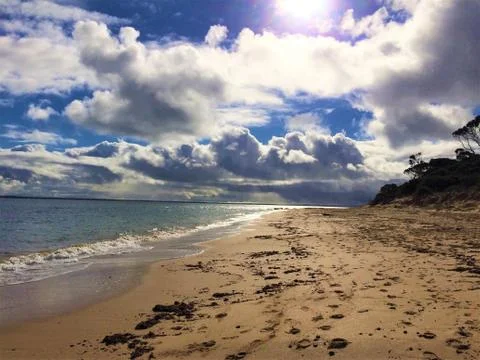 Sun Beaming through Clouds at Red Rocks Beach, Phillip Island Stock Photos