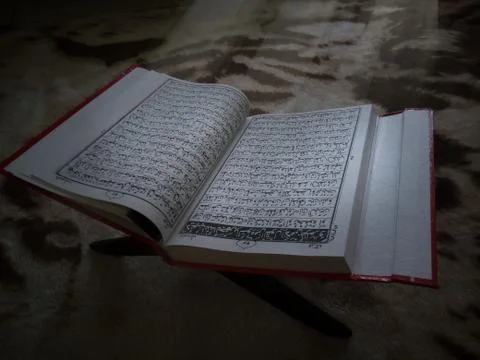 Sun beams falling on to opened Koran Stock Photos