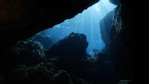 Sun beams rays light in cave underwater scuba divers to explore Stock Footage 175857680