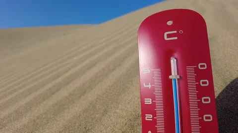 The sun beats down on a red thermometer stuck in a dune. Stock Footage 264802431