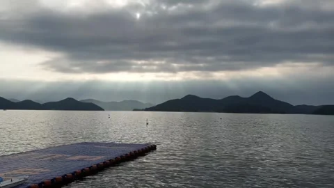 The sun beautifully hidden by clouds over the sea Stockbeeldmateriaal 256894891