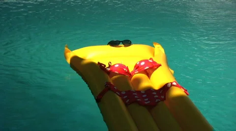 Sun bed floating in a pool Stock Footage 751158