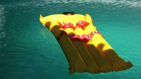 Sun bed floating in a pool Stock Footage 751218