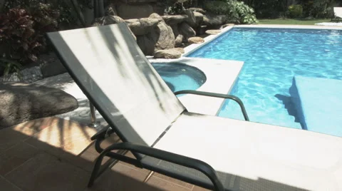 A sun bed by the pool Video stock 48784431