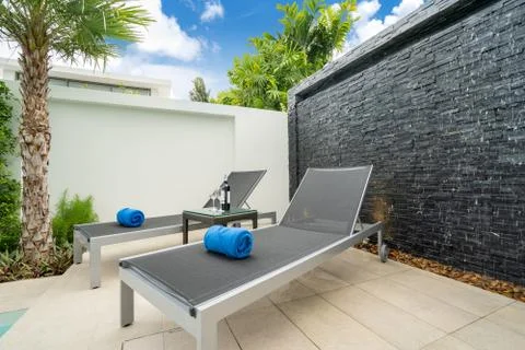 Sun bed by pool terrace Stock Photos