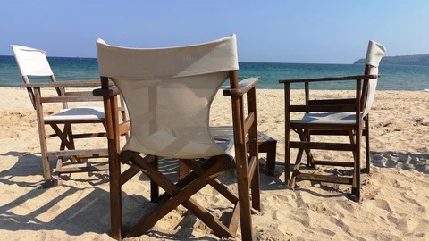 Sun beds on the deserted spring beach. Wind. Sun. Stock Footage 106834984