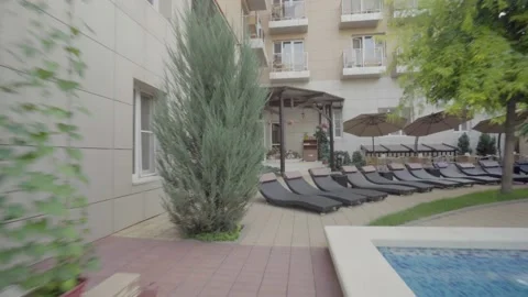 Sun beds by the pool in the hotel 動画素材 132065704