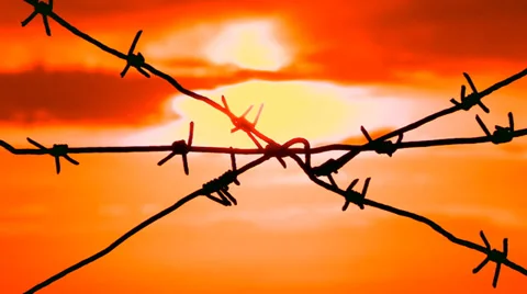 Sun behind barbed wire Stock Footage 30840250