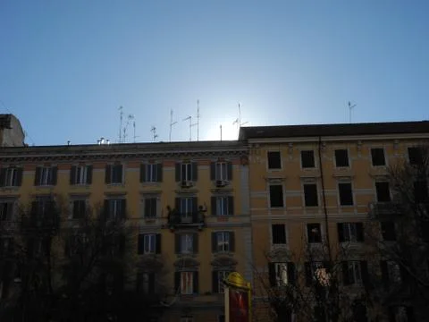 Sun behind buildings Stock Photos