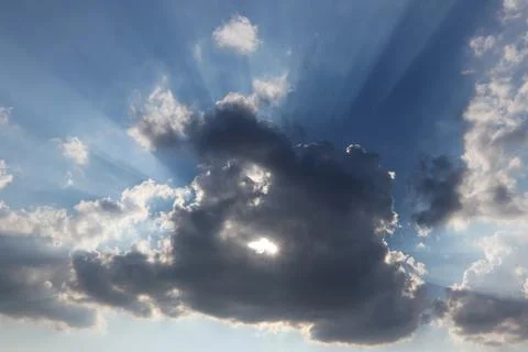 Sun behind the cloud with a hole Stock Photos