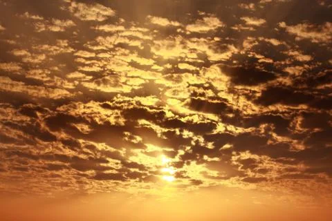 Sun behind cloud orange warm sky Stock Photos