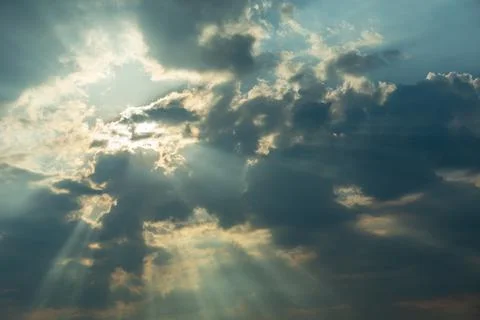 The sun behind the clouds and the sun's rays Stock Photos