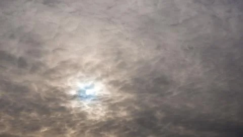 The sun behind the clouds blue sky Stock Photos