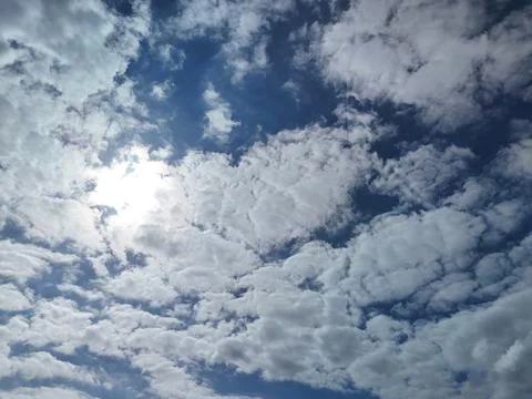 Sun Behind Clouds in Blue Sky with Cloud Texture Stock Photos