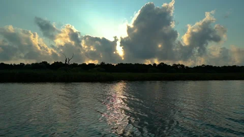 Sun behind clouds over lake Stock Footage 158465676