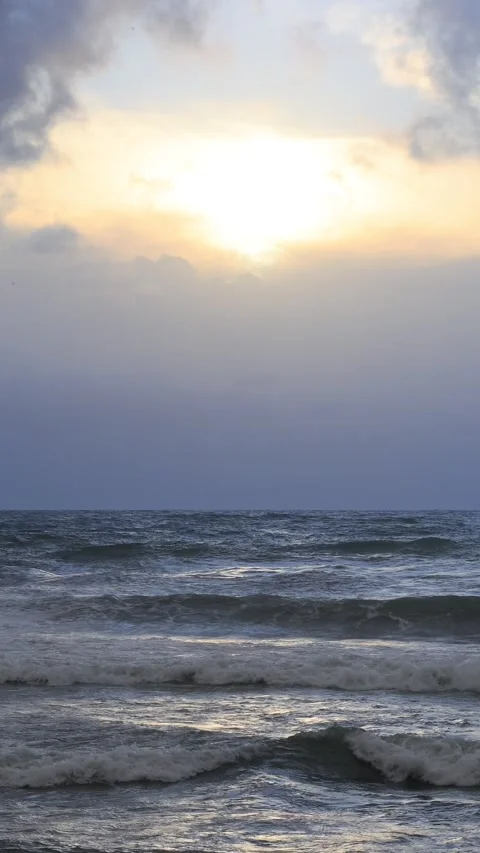 Sun Behind Clouds Over Stormy Sea Waves at Horizon Stock Footage 346252646