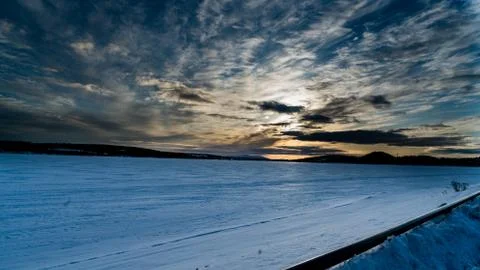 Sun behind clouds Stock Photos