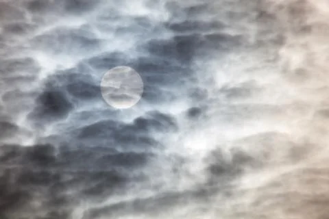 Sun behind clouds Stock Photos