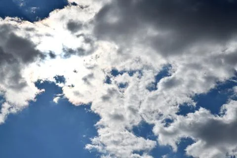 Sun behind clouds Stock Photos