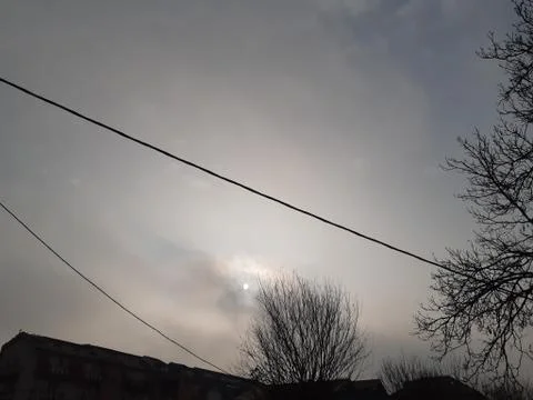 The Sun behind the clouds Stock Photos