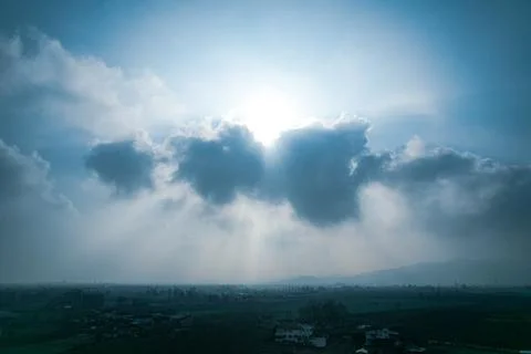 Sun behind clouds Stock Photos