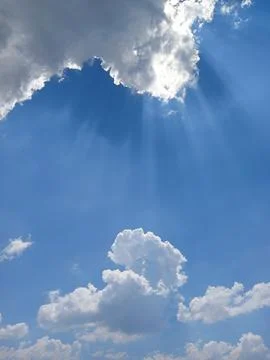 Sun behind clouds Stock Photos