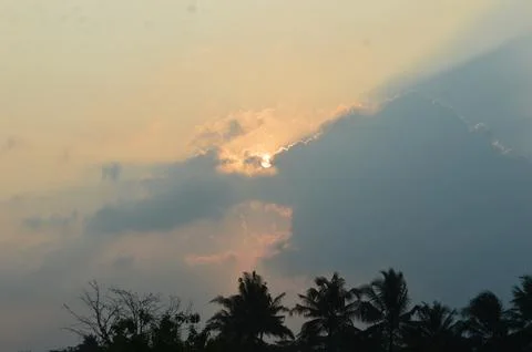 Sun behind the clouds of sunset Stock Photos