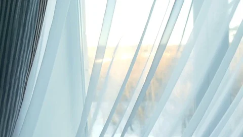 The sun behind the curtain in the window Vídeos de archivo 72566098