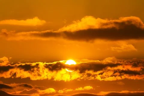 Sun behind dark cloud Stock Photos