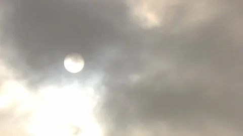 Sun behind dark clouds Stock Footage 281570909