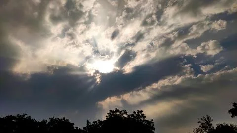 Sun behind the dark clouds Stock Photos