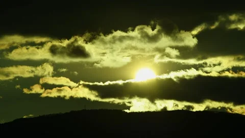 The sun behind the darkness clouds, time lapse. Stock Footage 326348597