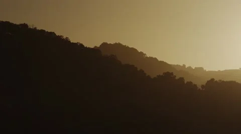 Sun behind hills Stock Footage 44447451