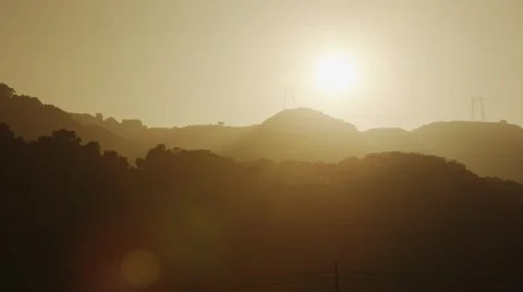 Sun behind hills pan up Stock Footage 44447407