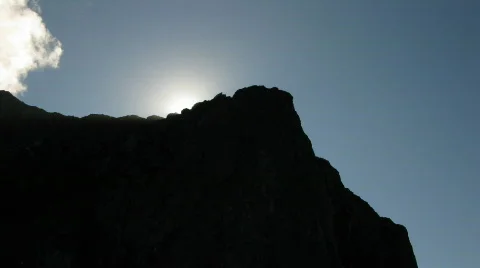 Sun behind rock timelapse tilt HD Stock Footage 369322