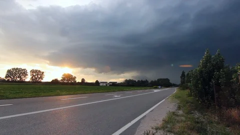 Sun behind storm clouds with lightening Stock Footage 125883681