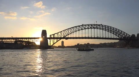 Sun behind Sydney Harbour Bridge and ferry Stock Footage 52862880