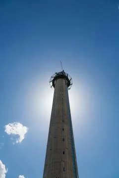 Sun behind tall tower Stock Photos