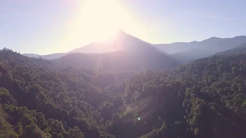 Sun Behind Volcano Aerial Video stock 100683528