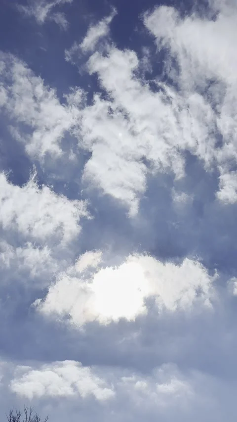 Sun Behind White Clouds in Deep Blue Sky Видео 344883593