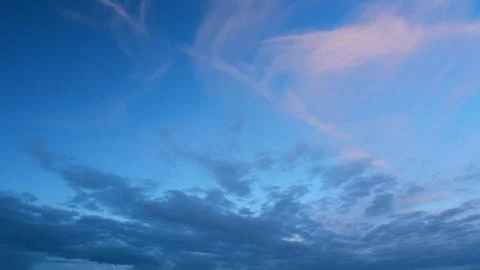 Sun below horizon and clouds in fiery dramatic sky. Cirrus clouds illuminated by Stock Photos