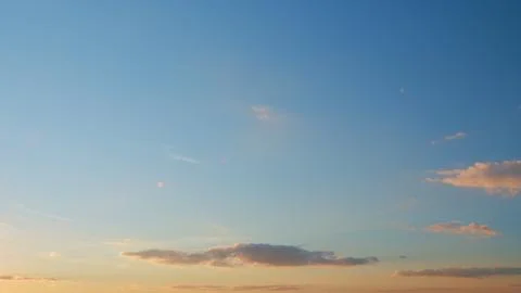 Sun below the horizon and clouds in the fiery dramatic sky. Clouds illuminated Stock Photos
