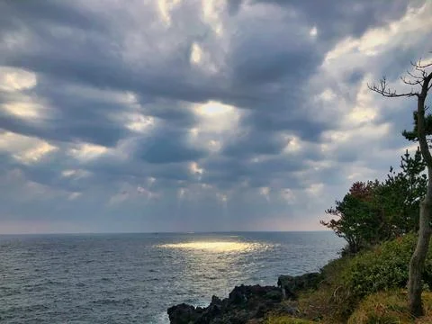 The sun between the clouds on the sea Stock Photos