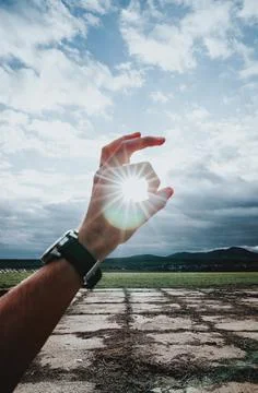 Sun between two fingers Stock Photos