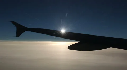 Sun blinking behind an airplane wing Stock Footage 42956502