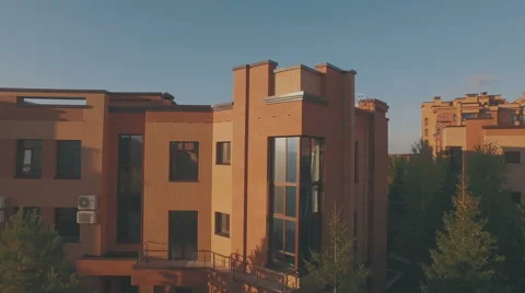 Sun blinking in the window of modern townhouse, aerial shot Stock Footage 55383962