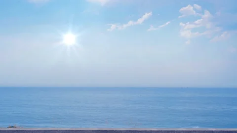 Sun on blue sky with clouds and sea, slow motion Video stock 92786146