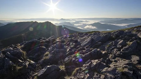 The sun in the blue sky over the mountains, the landscape in the valley covered Stock-Footage 255740193