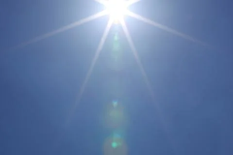 Sun in blue sky Stock Photos