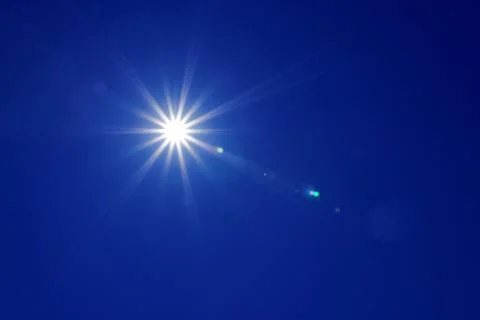 Sun in blue sky Stock Photos